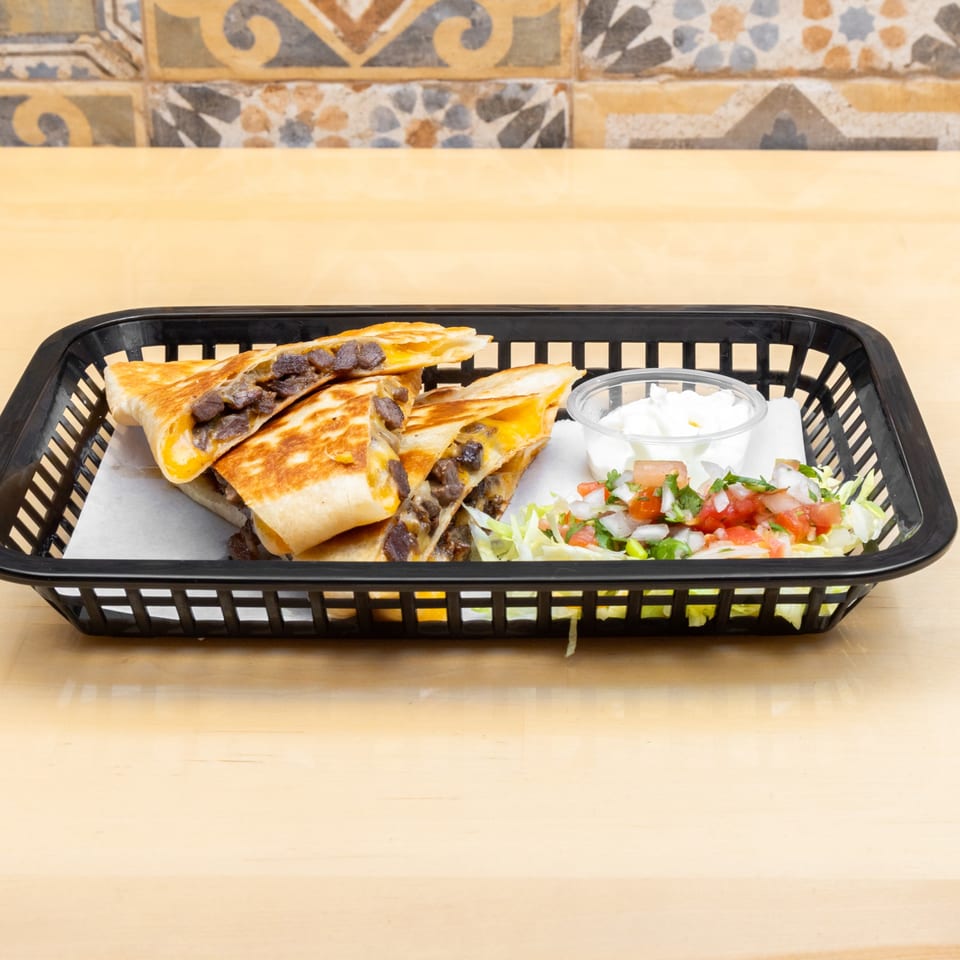 Four quesadilla wedges with meat and cheese, served with sour cream and pico de gallo.